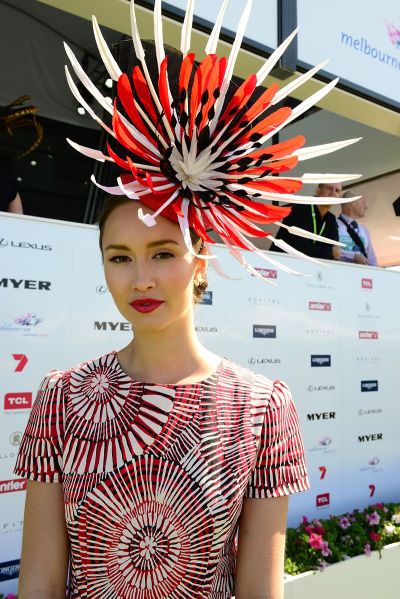 A featherless being sporting a large "fascinator" with feathers.